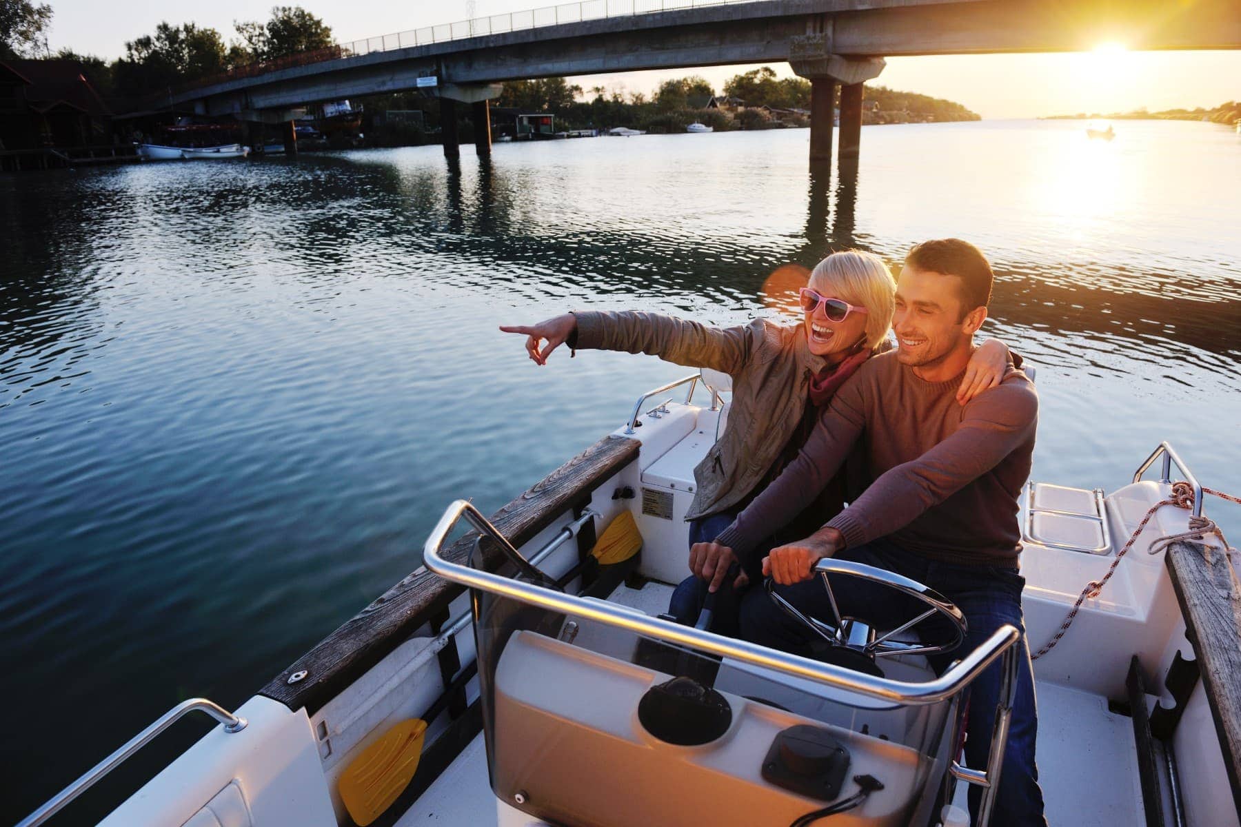 couple-riding-boat-sunset